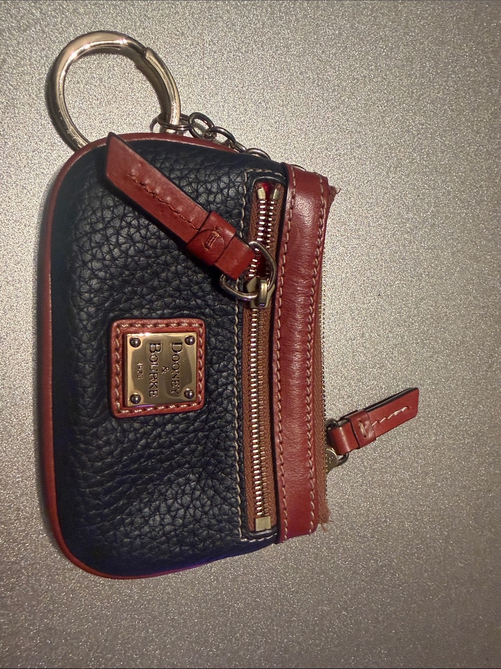 Dooney & Bourke Black Pebbled Leather Coin Pouch with Brown Trim and Gold Plate